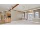 Open living space with view of kitchen, featuring vaulted ceiling and neutral carpet at 400 S Prairie Trce, Muncie, IN 47304