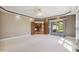 Spacious living room featuring recessed lighting, crown molding, french doors and access to the outdoor patio at 400 S Prairie Trce, Muncie, IN 47304