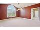 Living room features large window, white carpet, and modern light fixture at 400 S Prairie Trce, Muncie, IN 47304
