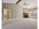 Cozy living room with fireplace, vaulted ceilings, and neutral carpet at 400 S Prairie Trce, Muncie, IN 47304