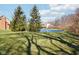 A tranquil pond reflects the sky and enhances the beauty of the expansive green lawn at 400 S Prairie Trce, Muncie, IN 47304