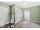Cozy bedroom featuring hardwood floors, natural light, and closet space at 412 N Riley Ave, Indianapolis, IN 46201