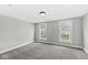 A light-filled bedroom with carpeted floors, and two windows at 412 N Riley Ave, Indianapolis, IN 46201
