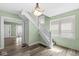 Well-lit foyer featuring a staircase and hardwood floors at 412 N Riley Ave, Indianapolis, IN 46201