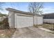 A detached garage with a white door and concrete driveway offers parking and storage space at 412 N Riley Ave, Indianapolis, IN 46201