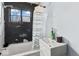 Bathroom needing remodel showcases tub/shower, toilet, window, and sink at 5006 W Naomi St, Indianapolis, IN 46241