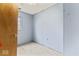 Bedroom needing remodel showcases single window, wood paneling, and door at 5006 W Naomi St, Indianapolis, IN 46241