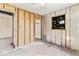 Bedroom needing remodel showcases single window, closet, wood paneling, and door at 5006 W Naomi St, Indianapolis, IN 46241