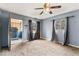 Bedroom with a ceiling fan, ample natural light, and access to the entryway at 5006 W Naomi St, Indianapolis, IN 46241