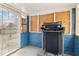 Entryway with a treadmill, a metal security door and unfinished walls at 5006 W Naomi St, Indianapolis, IN 46241