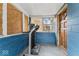 A compact entryway with a treadmill, and access to an exterior door at 5006 W Naomi St, Indianapolis, IN 46241