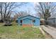 Charming blue house with a brick facade and small windows, surrounded by a lawn at 5006 W Naomi St, Indianapolis, IN 46241