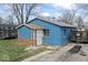 Cozy single-story home with a blue exterior, brick accents, and a quaint entrance at 5006 W Naomi St, Indianapolis, IN 46241