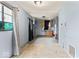 Kitchen area with vintage cabinets and an adjacent room partially demoed at 5006 W Naomi St, Indianapolis, IN 46241
