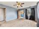 Living room featuring neutral carpet, with doors to adjacent entry and rooms at 5006 W Naomi St, Indianapolis, IN 46241