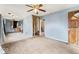 Room with blue walls, a ceiling fan, and adjacent rooms partially demoed at 5006 W Naomi St, Indianapolis, IN 46241