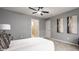 This spacious bedroom features a neutral color palette, a ceiling fan, and art deco furnishings at 503 Lockerbie N Cir, Indianapolis, IN 46202