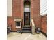 Rear entrance with black metal stairs, brick facade, and potted plants at 503 Lockerbie N Cir, Indianapolis, IN 46202