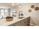 A kitchen offers an eat-in bar with a stainless sink, a neutral color palette, and direct access to the living room at 503 Lockerbie N Cir, Indianapolis, IN 46202