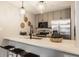 A modern kitchen features gray cabinets, stainless steel appliances, and a breakfast bar with stylish pendant lighting at 503 Lockerbie N Cir, Indianapolis, IN 46202