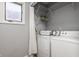 Laundry room features modern washer and dryer units and practical shelving at 503 Lockerbie N Cir, Indianapolis, IN 46202