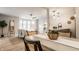 An open concept living space with hardwood floors features a dining area, a modern kitchen, and a comfortable living room at 503 Lockerbie N Cir, Indianapolis, IN 46202