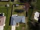 Aerial view of a backyard with a firepit, shed, pool, a fenced yard, and a well-maintained lawn at 511 Windward Ln, Plainfield, IN 46168