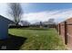 Large backyard featuring a well-maintained lawn, privacy fence, and room for various outdoor activities at 511 Windward Ln, Plainfield, IN 46168