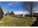 Spacious backyard with a large grassy area, a fence, and a shed, perfect for outdoor activities at 511 Windward Ln, Plainfield, IN 46168