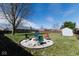 Backyard featuring a firepit, shed, and well-maintained lawn, perfect for outdoor enjoyment and relaxation at 511 Windward Ln, Plainfield, IN 46168