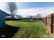 Large backyard featuring a well-maintained lawn, privacy fence, and room for various outdoor activities at 511 Windward Ln, Plainfield, IN 46168