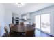 Bright dining area adjacent to the kitchen features sliding glass doors and stylish modern furnishings at 511 Windward Ln, Plainfield, IN 46168