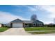 Charming single-story brick home boasts an attached garage, updated roof and meticulously kept front lawn at 511 Windward Ln, Plainfield, IN 46168