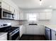 Bright kitchen featuring white cabinets, stone counter tops and stainless steel appliances at 511 Windward Ln, Plainfield, IN 46168