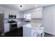 Modern kitchen with stainless steel appliances, white cabinets, subway tile, and stone countertops at 511 Windward Ln, Plainfield, IN 46168