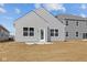 Backyard view of home with vinyl siding, windows, and a concrete patio at 5207 Rolling Meadow Blvd, Indianapolis, IN 46237