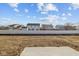 View of home's backyard, surrounded by a white fence and view of neighbors at 5207 Rolling Meadow Blvd, Indianapolis, IN 46237