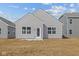 Backyard view of home with vinyl siding, windows, and a concrete patio at 5207 Rolling Meadow Blvd, Indianapolis, IN 46237