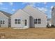 Backyard view of home with vinyl siding, windows, and a concrete patio at 5207 Rolling Meadow Blvd, Indianapolis, IN 46237