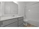 Bright bathroom featuring a shower-tub combo, toilet, and vanity with a light gray cabinet at 5207 Rolling Meadow Blvd, Indianapolis, IN 46237
