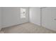 Bedroom featuring neutral carpet flooring, white walls and a window with double closets at 5207 Rolling Meadow Blvd, Indianapolis, IN 46237