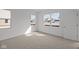Bright bedroom with neutral carpet, white walls, and natural light at 5207 Rolling Meadow Blvd, Indianapolis, IN 46237