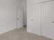 Bedroom featuring neutral carpet flooring, white walls, a hallway door and double closets at 5207 Rolling Meadow Blvd, Indianapolis, IN 46237