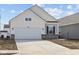 Charming single-Gathering home featuring a two-car garage and light color scheme at 5207 Rolling Meadow Blvd, Indianapolis, IN 46237
