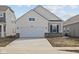 Charming single-Gathering home featuring a two-car garage and light color scheme at 5207 Rolling Meadow Blvd, Indianapolis, IN 46237