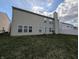 Spacious backyard with a large lawn and a view of the home's rear exterior at 5565 Noble Dr, Indianapolis, IN 46234