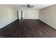 Large bedroom with neutral paint, ceiling fan, and a door which leads to other rooms at 5565 Noble Dr, Indianapolis, IN 46234