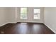 Bedroom features hardwood floors and sunlit windows overlooking the neighborhood at 5565 Noble Dr, Indianapolis, IN 46234