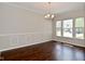 Classic dining room with a modern chandelier and natural light from large windows at 5565 Noble Dr, Indianapolis, IN 46234