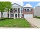 Traditional two-story brick home with stately white columns and a well-manicured lawn at 5565 Noble Dr, Indianapolis, IN 46234